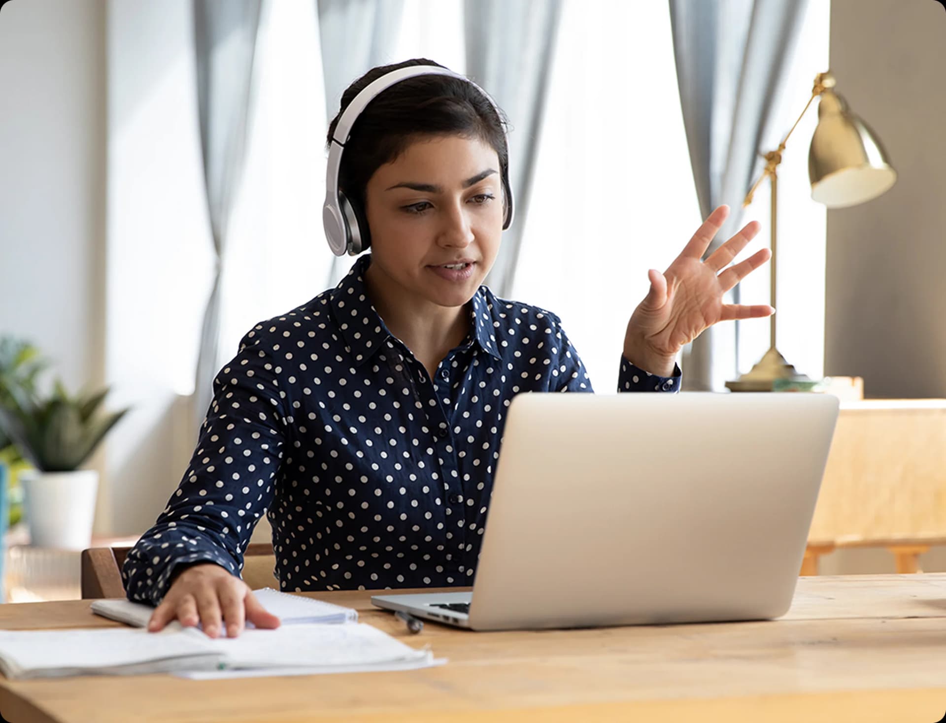 Designer reviewing clickable Figma prototype on a laptop with headphones