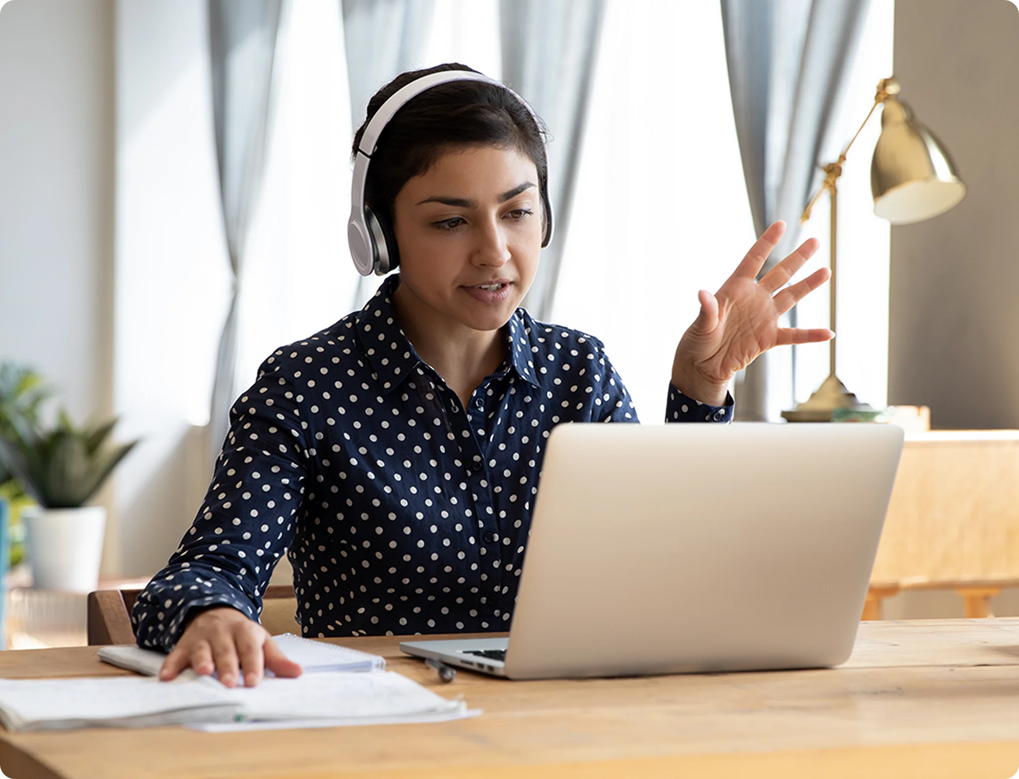 Designer reviewing clickable Figma prototype on a laptop with headphones